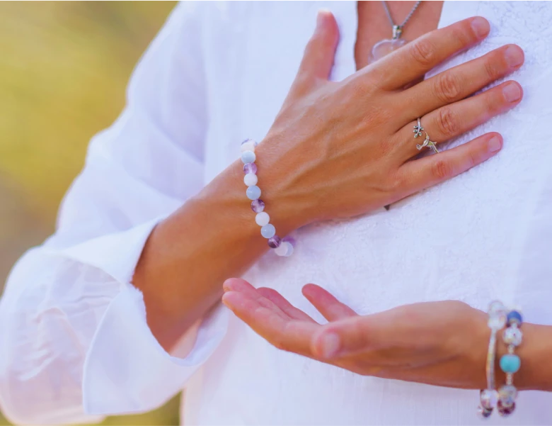 a woman with her hand on her chest