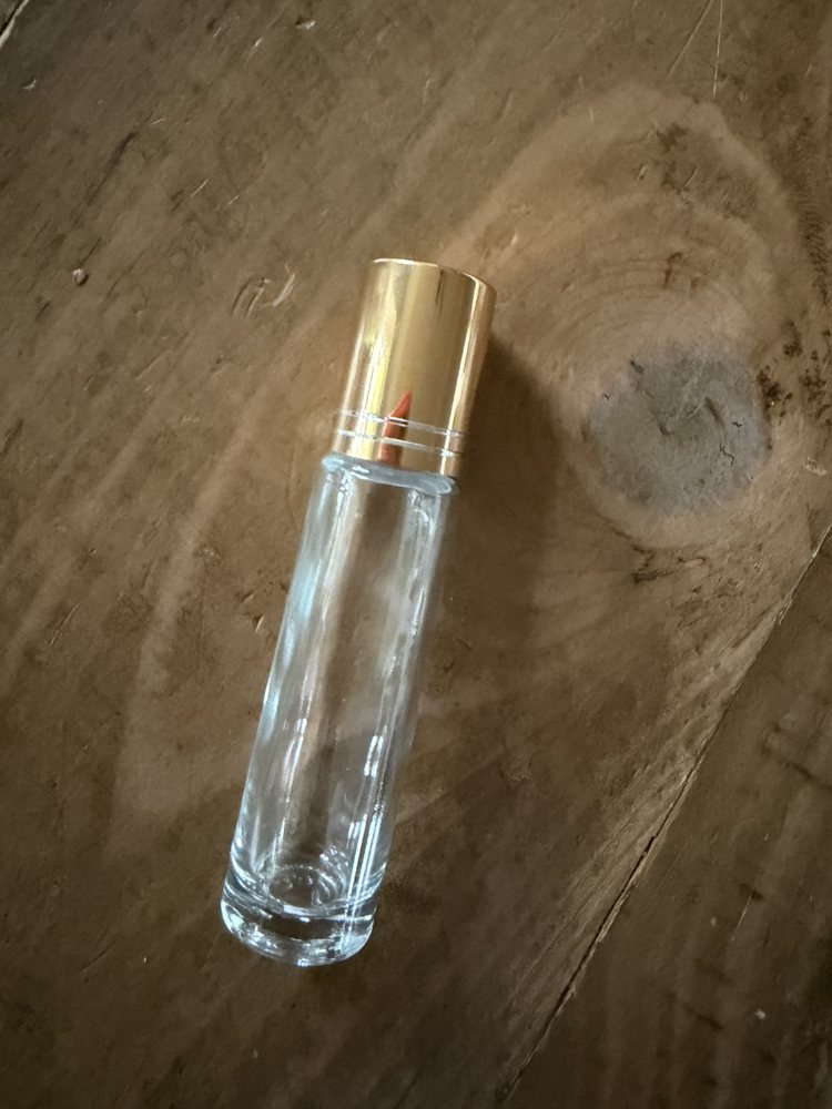 Glass roller bottle with gold cap